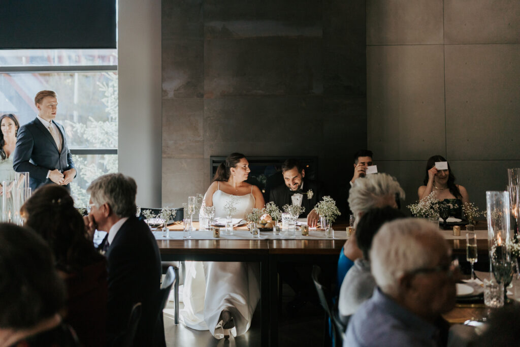 Modern Canmore wedding reception venue with floor-to-ceiling windows, glass staircase, outdoor patio, and seating for 70 guests near Banff.